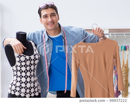 Male tailor with female student in workshop Male tailor with female student in workshop 99937222