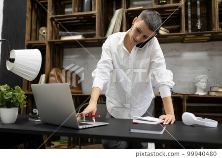 elegant businesswoman working in the company behind a laptop elegant businesswoman working in the company behind a laptop 99940480