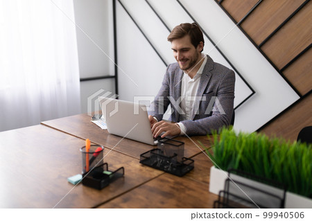 business lawyer studies the client's question while sitting at the table in the office and looking 99940506