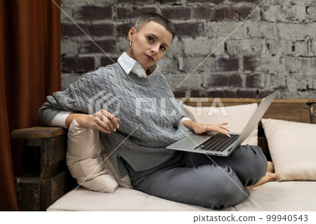 elegant businesswoman working in the company behind a laptop elegant businesswoman working in the company behind a laptop 99940543