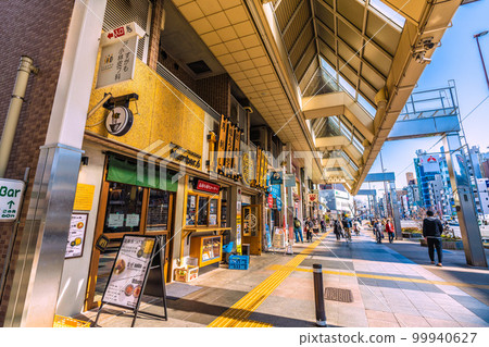 從購物街看 JR 巢鴨站和都營三田線巢鴨站入口 A1（屏幕右後方）的日本東京城市景觀 99940627