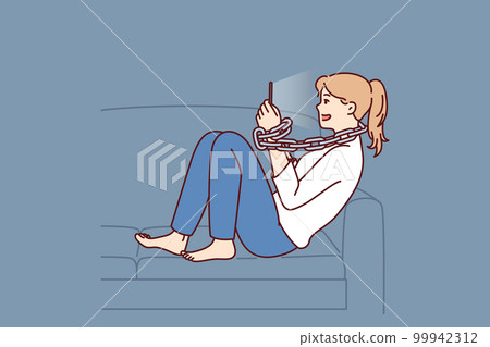 Young positive woman addicted to mobile phone sitting on sofa with chain around neck 99942312