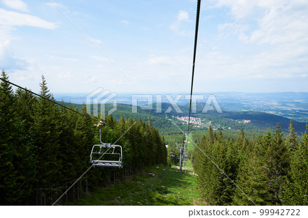 Ski lift in mountains. Karpacz resort in Poland with lift road. Mountain hiking and active vacation Ski lift in mountains. Karpacz resort in Poland with lift road. Mountain hiking and active vacation 99942722