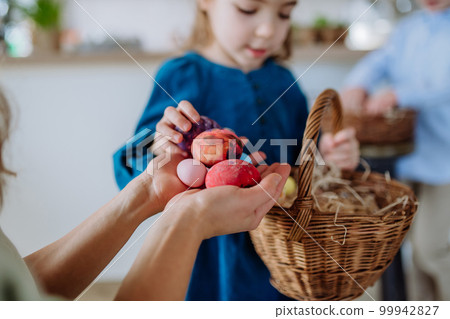 Little girl holding basket and showing her mother easter eggs which she found. Little girl holding basket and showing her mother easter eggs which she found. 99942827