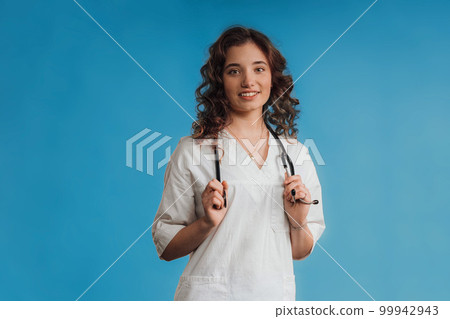 Portrait of young curly nurse, studio shoot. Portrait of young curly nurse, studio shoot. 99942943