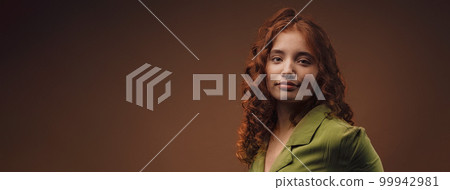 Portrait of young redhead woman, studio shoot. Portrait of young redhead woman, studio shoot. 99942981