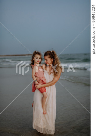Mother enjoying together time with her daughter at sea. 99943224