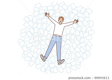 Young man lies among office papers in pose of angel, enjoying rest and not paying attention to mess Young man lies among office papers in pose of angel, enjoying rest and not paying attention to mess 99943611