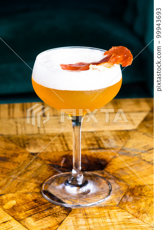 Stemmed cocktail glass with alcoholic drink, close-up isolated on black. Template design Stemmed cocktail glass with alcoholic drink, close-up isolated on black. Template design 99943693
