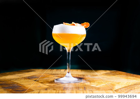 Stemmed cocktail glass with alcoholic drink, close-up isolated on black. Template design 99943694