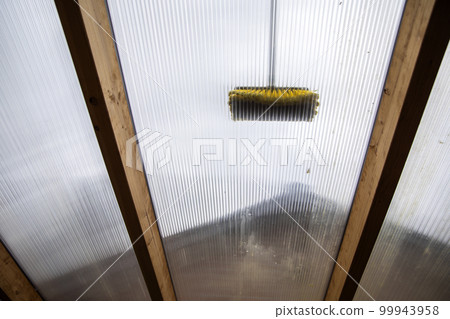 Washing the patio pergola roof cover made of aluminum. removing the dirty algae with brush soap and water close up in garden from a house terrace Washing the patio pergola roof cover made of aluminum. removing the dirty algae with brush soap and water close up in garden from a house terrace 99943958