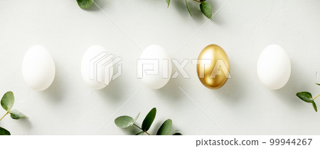 White chicken eggs with one golden egg flat lay top view banner White chicken eggs with one golden egg flat lay top view banner 99944267