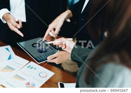 Business group people meeting and discuss to come up with conclusions on market, investment and marketing planning based on the financial budget provided by the company. Business group people meeting and discuss to come up with conclusions on market, investment and marketing planning based on the financial budget provided by the company. 99945847