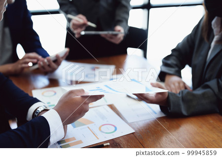 Business group people meeting and discuss to come up with conclusions on market, investment and marketing planning based on the financial budget provided by the company. Business group people meeting and discuss to come up with conclusions on market, investment and marketing planning based on the financial budget provided by the company. 99945859