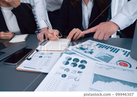 Closeup focus on BI dashboard with office worker in harmony office. 99946307