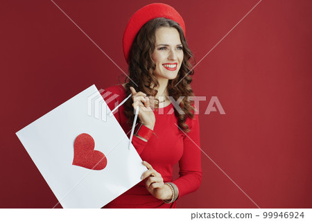 happy woman against background with shopping bag and heart 99946924