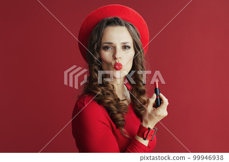 elegant female isolated on red background sending kiss 99946938