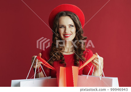 smiling stylish woman on background with shopping bags 99946943