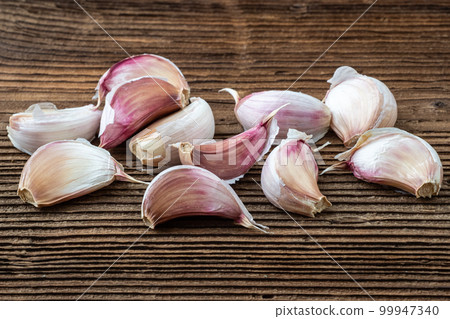 Garlic on dark rustic wooden background. Garlic on dark rustic wooden background. 99947340