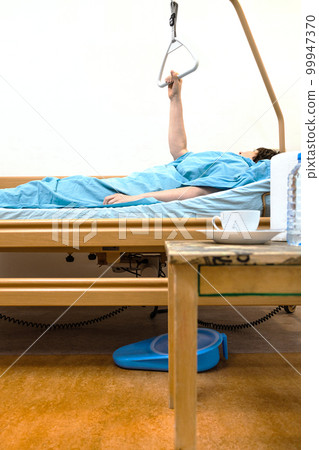 side view of hospital bed with sick person at home 99947370