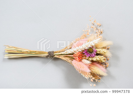 bouquet of dried flower and spikelets lies on gray bouquet of dried flower and spikelets lies on gray 99947378
