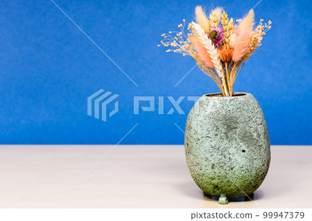 vase with bouquet of dried flowers on table 99947379