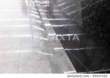 reflection of illumination in grey flooring tiles reflection of illumination in grey flooring tiles 99947384