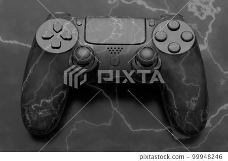 Realistic video game joystick with black marble texture on black background. 99948246