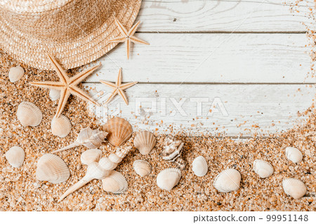 Sand seashells background. Summer time concept with sea shells and starfish on wooden background and sand Sand seashells background. Summer time concept with sea shells and starfish on wooden background and sand 99951148