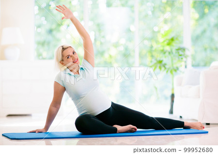 Pregnancy yoga. Exercise for pregnant woman. Pregnancy yoga. Exercise for pregnant woman. 99952680