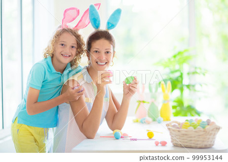Mother and kids, family coloring Easter eggs. Mother and kids, family coloring Easter eggs. 99953144