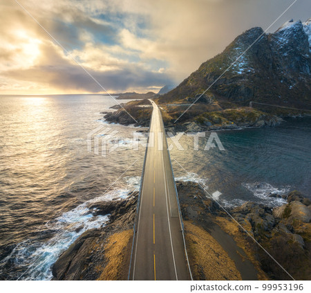 Aerial view of bridge, sea with waves and mountains at sunset Aerial view of bridge, sea with waves and mountains at sunset 99953196