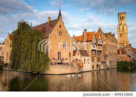 Architecture of idyllic Bruges with canal and swans floating in a row, Flanders, Belgium Architecture of idyllic Bruges with canal and swans floating in a row, Flanders, Belgium 99953866