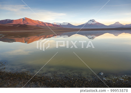 Salt lake Lejia reflection, idyllic volcanic landscape at Sunset, Atacama, Chile 99953878