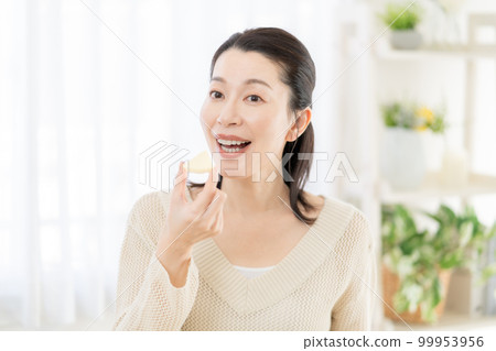 Intestinal activity A middle-aged woman eating cheese 99953956