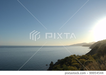 Sunset on tropical beaches next to the mountains, Maro, Spain 99954544