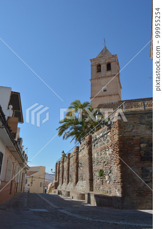 Bell tower and walls of Santa Maria Church a sunny day, Velez Malaga Bell tower and walls of Santa Maria Church a sunny day, Velez Malaga 99955254