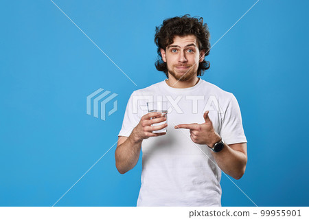 man in white t-shirt showing drinking glass of water man in white t-shirt showing drinking glass of water 99955901