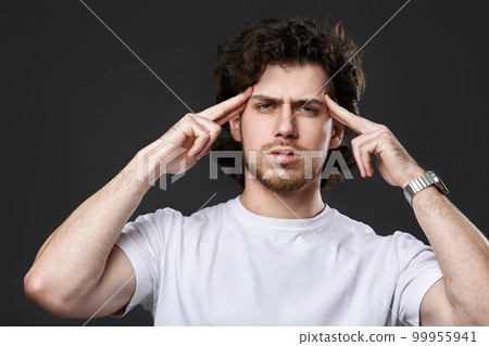 young bearded man showing victory gesture holding fists raising hands up on gray background 99955941