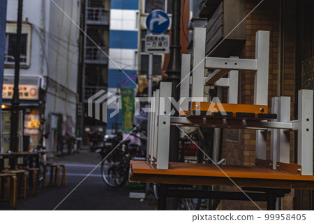 Shinjuku's bar district during the daytime, stacked tables Shinjuku's bar district during the daytime, stacked tables 99958405