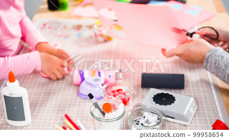 Kids papercraft. Making paper bugs out of the empty toilet paper rolls and construction paper. 99958654