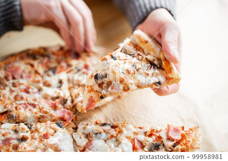 one people taking slices of pizza out of the box. fast delivery of food. packaging for fast food. top view one people taking slices of pizza out of the box. fast delivery of food. packaging for fast food. top view 99958981