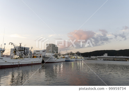 Fishing boats moored at the fishing port in the evening 99959734