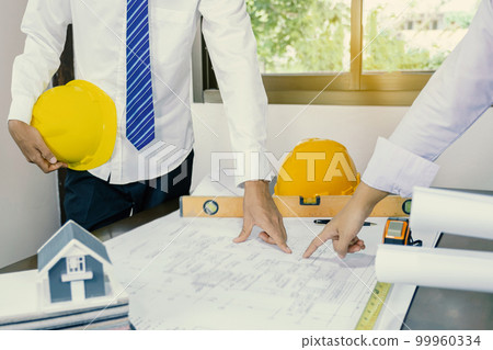 engineers hand pointing to housing plan, contractors meetings for projects, 99960334