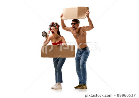Gender equality. Young man and woman emotionally shouting at strike, protesting with cardboard tablets isolated over white background Gender equality. Young man and woman emotionally shouting at strike, protesting with cardboard tablets isolated over white background 99960537