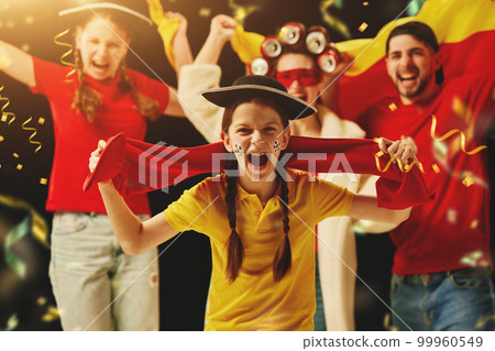 Group of emotional young people and teens cheering up german football team during championship. Successful winning game 99960549