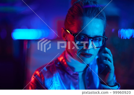 Portrait of pensive modern woman speaking on smartphone 99960920