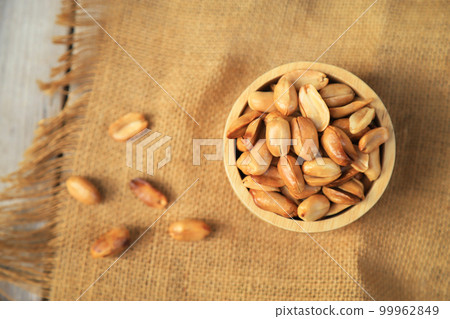 Yellow roasted groundnut on sack for healthy food eating or being in cooking ingredient. selective focus. 99962849