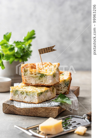 Chicken broccoli cheesy sliced casserole on wooden board on gray background with text space. Healthy food 99963206