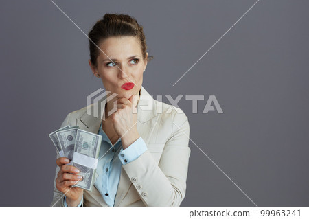 pensive 40 years old business woman in light business suit 99963241